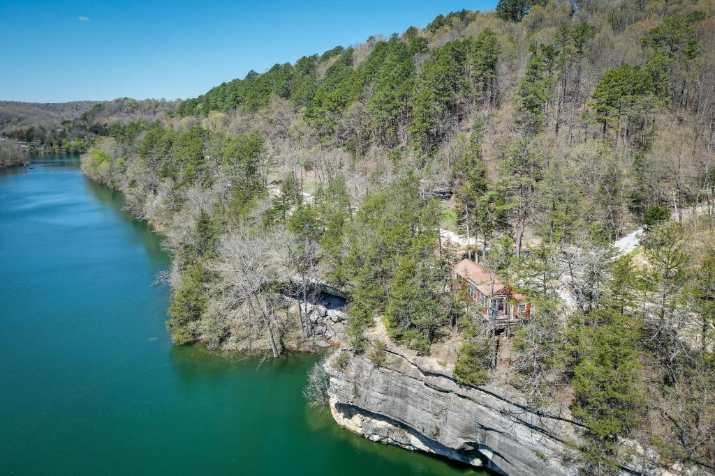 an aerial view of a house on a cliff next to a river at Cliffside Eureka Springs Cabin with Beaver Lake View in Eureka Springs