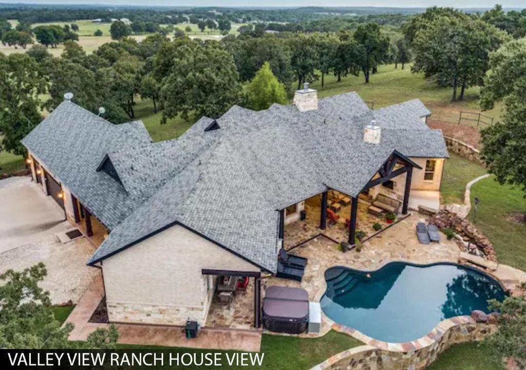 an aerial view of a house with a swimming pool at Hilltop Ranch House - Holiday & Family Destination in Valley View