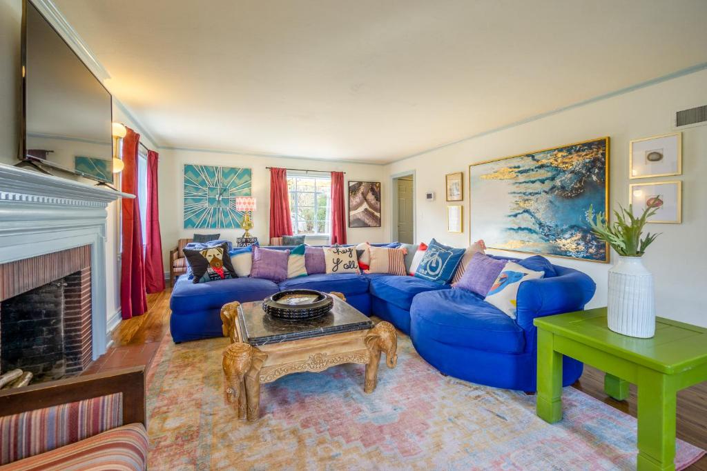 a living room with a blue couch and a table at Comfy Colonial - up to 15 ppl 5 mins to Plaza District or State Fair in Oklahoma City