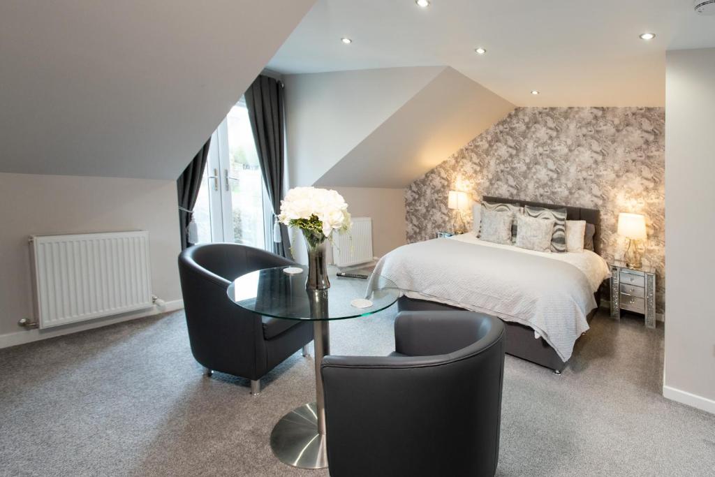 a bedroom with a bed and a table and chairs at 3 Private bedrooms attached to hosts home Free parking in Perth