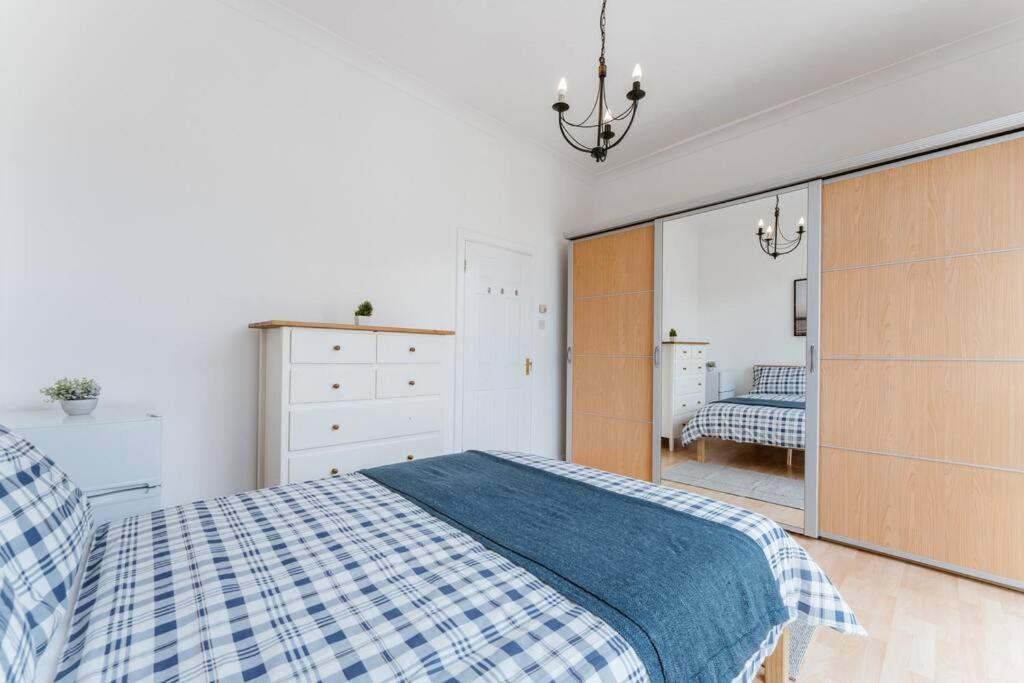 a bedroom with a bed and a large mirror at Comfortable Double Room for Your London Getaway in London