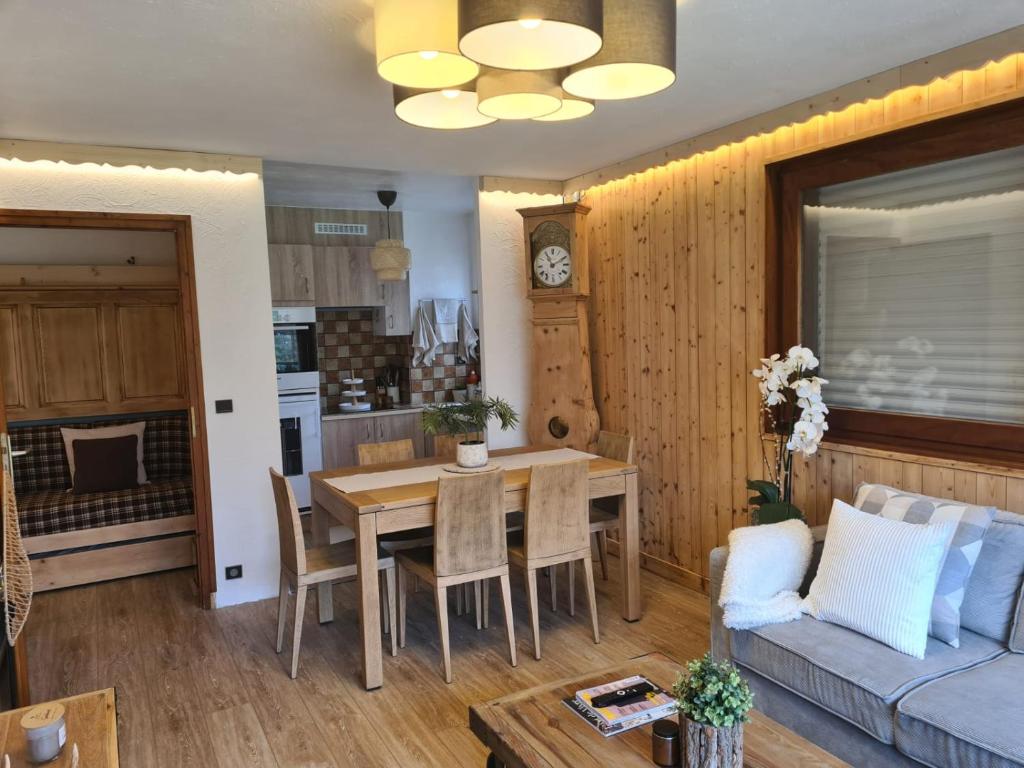 eine Küche und ein Wohnzimmer mit einem Tisch und einer Couch in der Unterkunft Luxury holidays apartment Praz sur Arly in Praz-sur-Arly