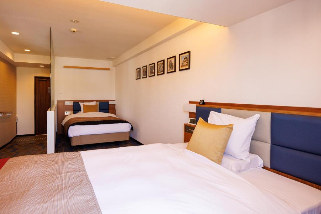 Postel nebo postele na pokoji v ubytování Floral Hotel East Shinsaibashi
