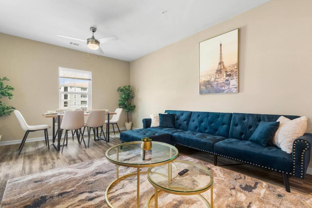 a living room with a blue couch and a table at Elegant 3BR/2BA Condo Near Beaches & Attractions in Melbourne