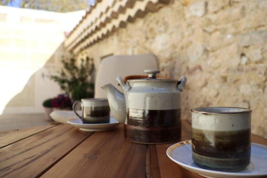 two coffee cups sitting on a wooden table at Uzès médiévale l&#39;écrin d&#39;Amalia in Uzès