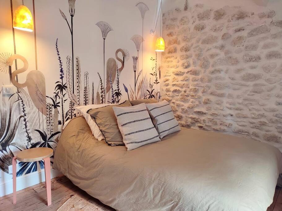 a bedroom with a bed with pillows on it at Uzès médiévale l&#39;écrin d&#39;Amalia in Uzès