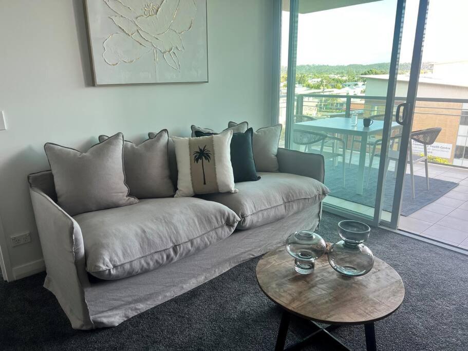 a living room with a couch and a table at Pavillions - Hosted by Burleigh Letting in Gold Coast