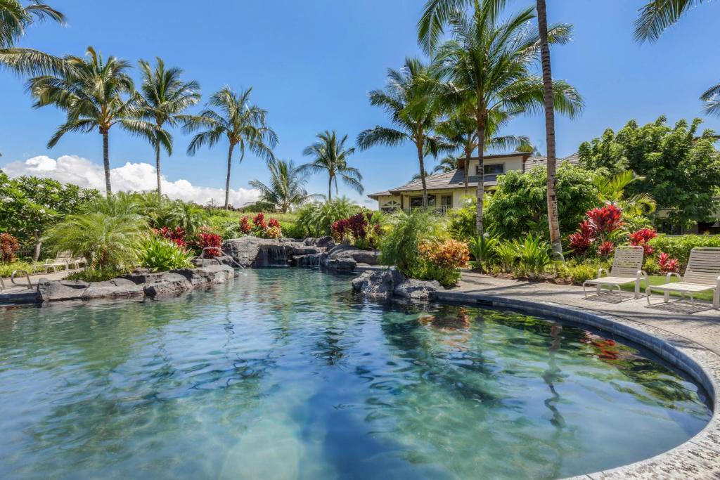 a pool at a resort with palm trees at Palm Villas 2 Bed/2 Bath Loft #F22 in Waikoloa