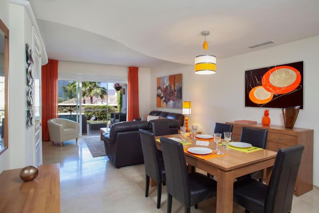 a dining room and living room with a table and chairs at Mediterranean Townhouse CalaGolf in Mijas