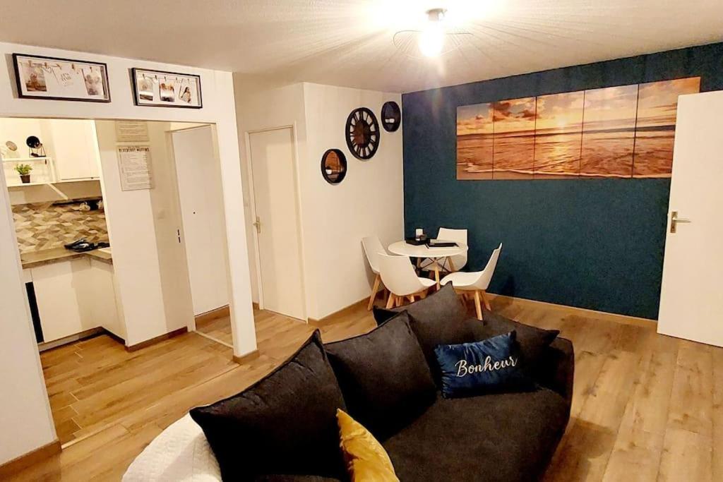 a living room with a couch and a table at appartement cosy Strasbourg in Strasbourg