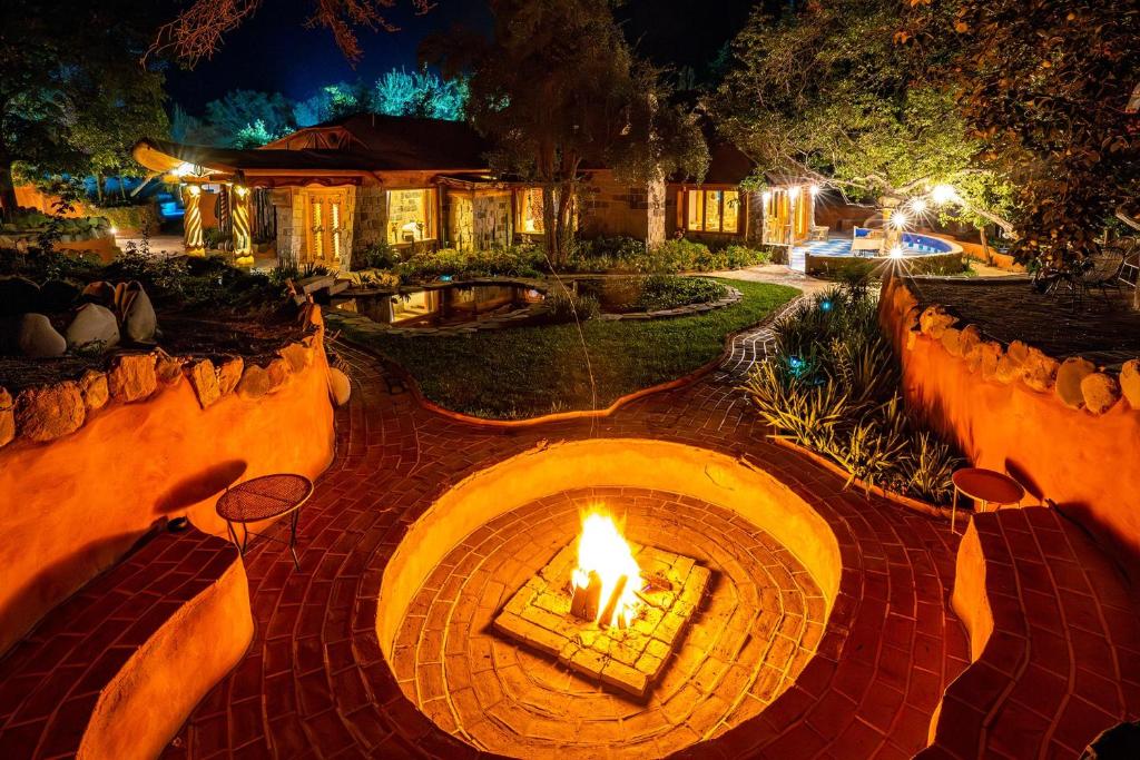 a fire pit in the middle of a yard at night at Casa Primal in San José de Maipo