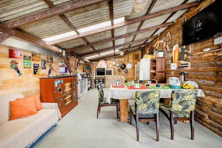 a kitchen with a table and chairs in a room at Pousada Rancho 60 in Balneário Camboriú