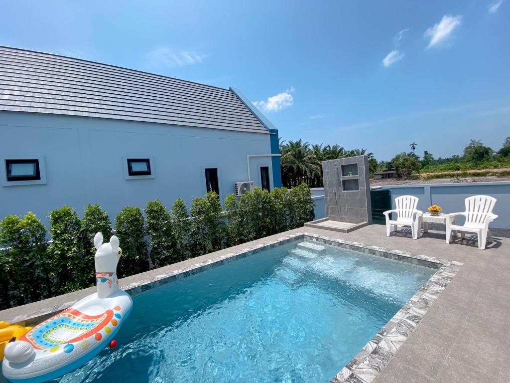 a swimming pool with an inflatable pool noodle in a backyard at 286poolvilla in Surat Thani