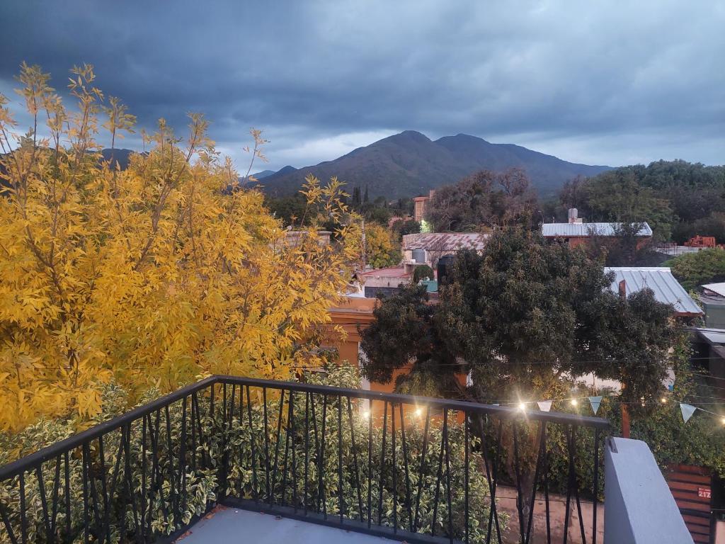 a balcony with a view of a city and mountains at Utopia byb in Capilla del Monte