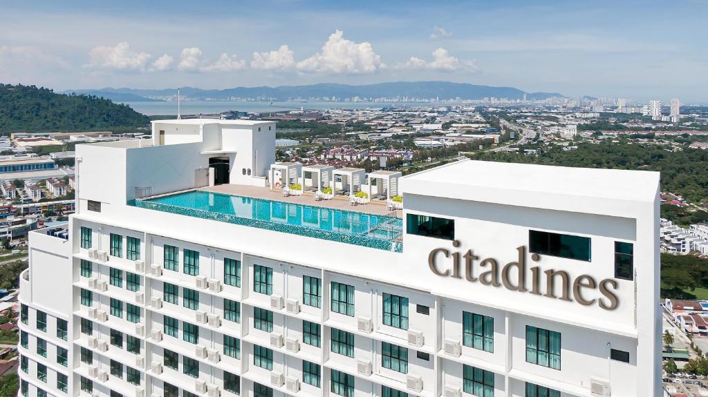 a building with a swimming pool on top of it at Citadines Prai Penang in Bukit Mertajam