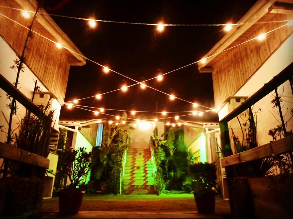 a string of lights hanging over a house at night at Pousada Villa Del Mar in Farol de Santa Marta