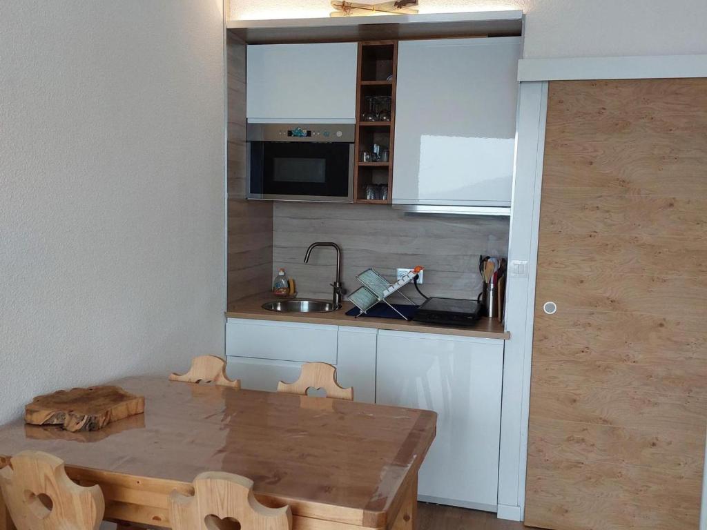 a kitchen with a wooden table and a sink at Studio Villard-de-Lans, 1 pièce, 4 personnes - FR-1-515-168 in Villard-de-Lans
