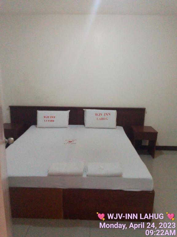 a bed with two white pillows on top of it at WJV INN LAHUG in Tabok