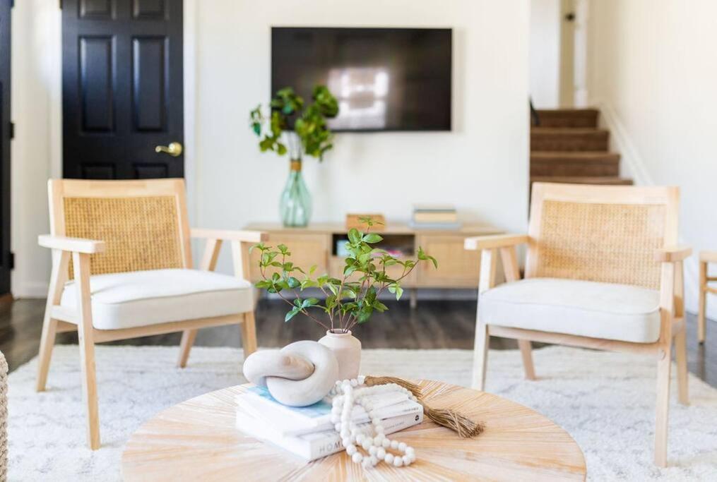 a living room with two chairs and a table with books at Cozy getaway - 5 min drive to beach in Cape May