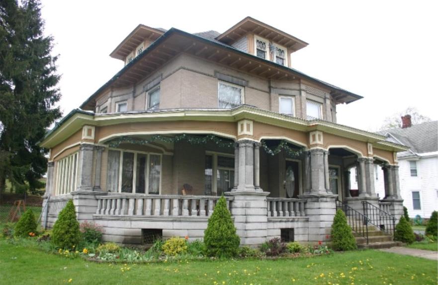 a large house with a porch on a lawn at Tarry Here Mansion Bed & Breakfast in Salamanca