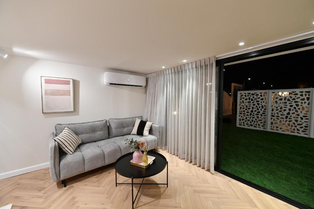 a living room with a couch and a table at צימר רפאל in Eilat