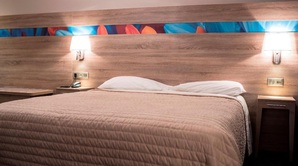 Postel nebo postele na pokoji v ubytování Hotel Restaurant Le Coquelicot