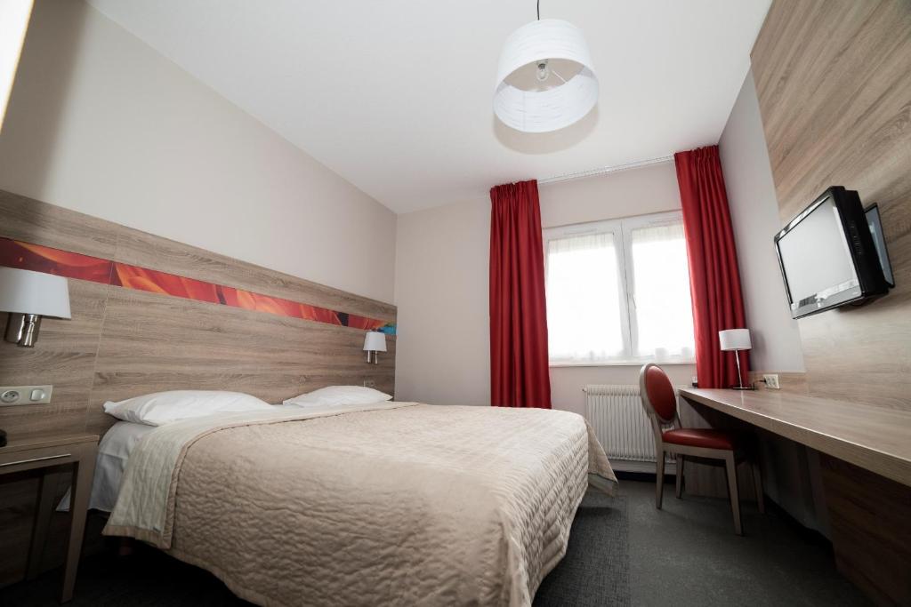 Postel nebo postele na pokoji v ubytování Hotel Restaurant Le Coquelicot
