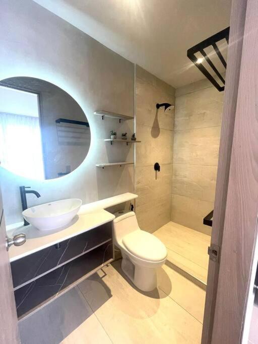 a bathroom with a white toilet and a sink at Apartamento nuevo de lujo in Barranquilla