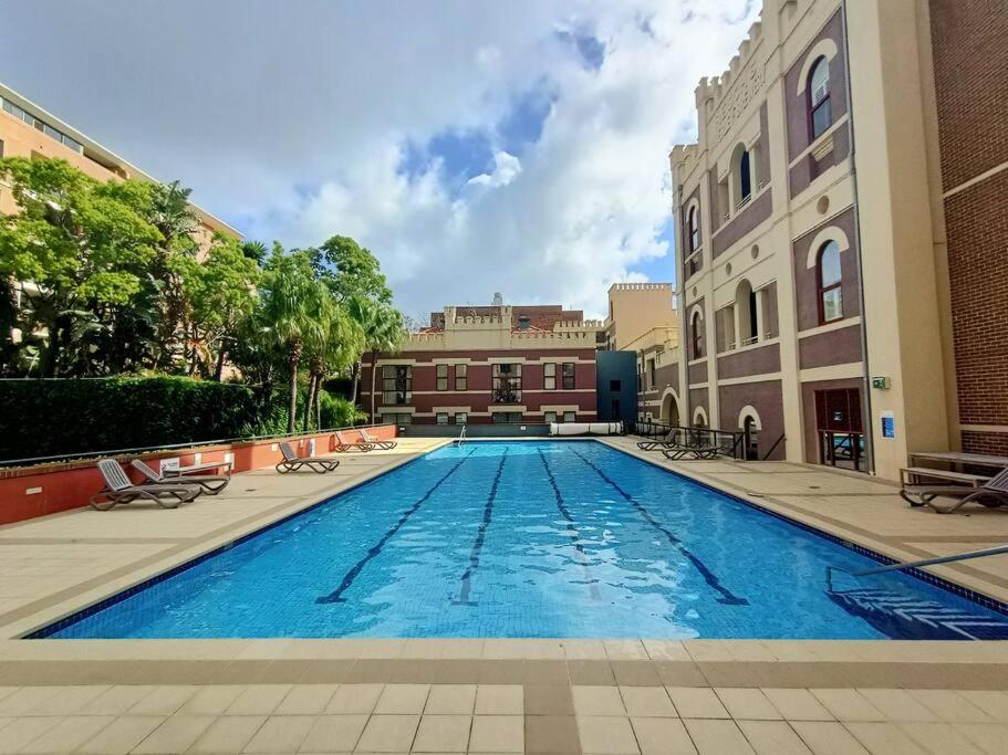 a large swimming pool in the middle of a building at Homely Apartment In Sought After Building in Sydney