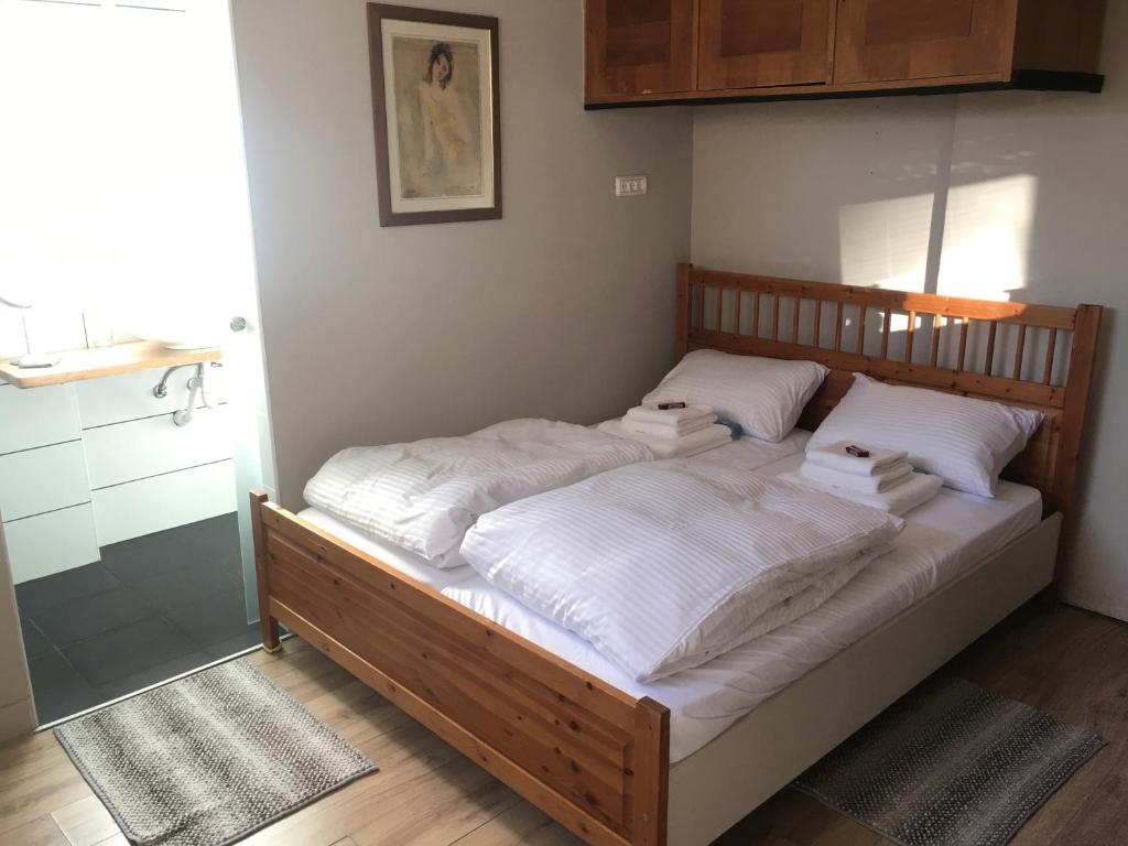 a bedroom with a large bed with white sheets at Bialik St B&B room Bauhaus district Tel Aviv in Tel Aviv