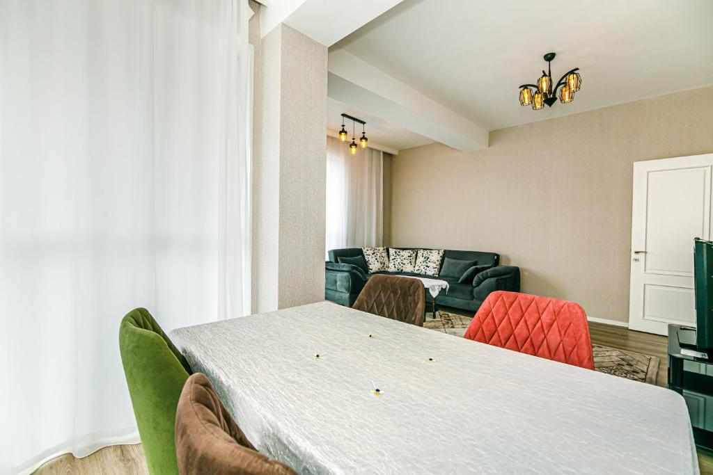 a living room with a table and chairs and a couch at Sabah Residance Garden Wiev in Baku