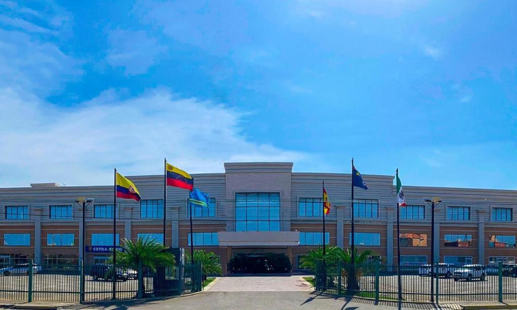 a building with flags in front of it at Hotel Las Palmas Inn in Punto Fijo