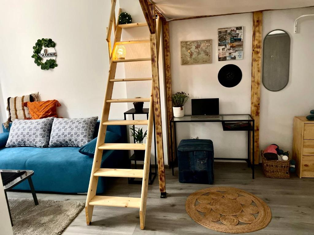 a room with a ladder and a bed and a desk at Vis-a-Vis Studio - Gara de Nord in Bucharest