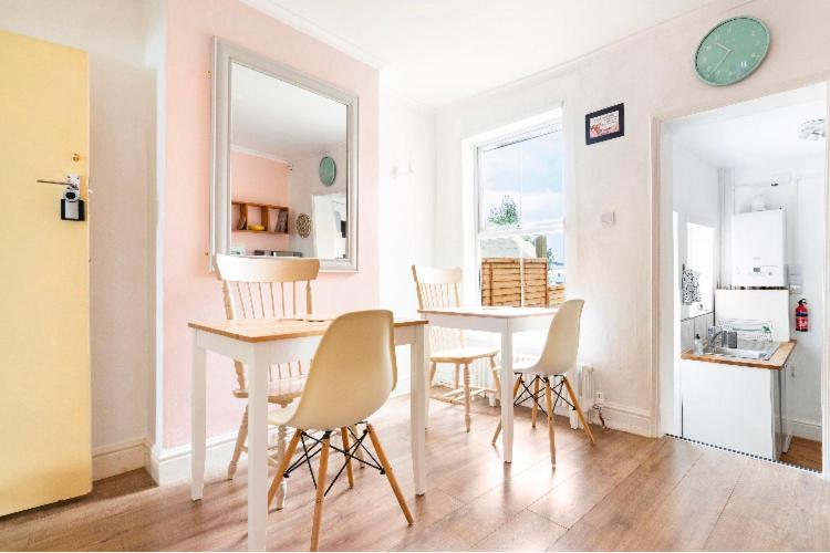 a dining room with a table and chairs at Nice bedroom close to the train station and the city centre in Norwich