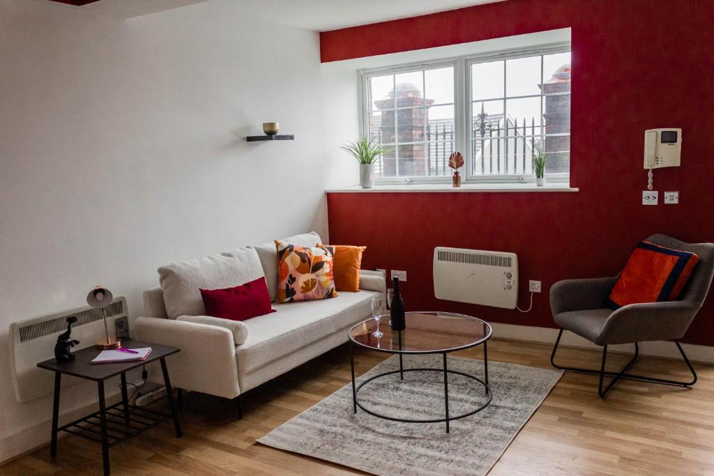a living room with a couch and a table at Cozy and Modern 2-bed apartment in Swansea