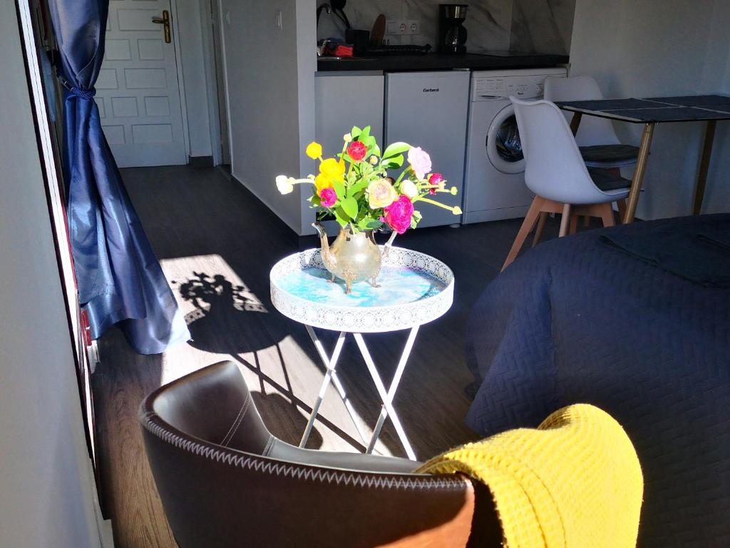 a vase of flowers on a table in a room at Sunny studio La Mata beach in Torrevieja
