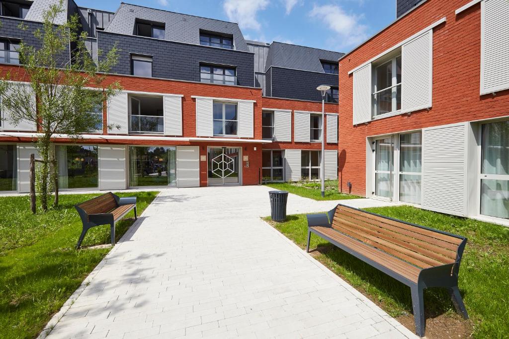 two benches sitting in front of a building at Le Domaine des Diamants Blancs in Croix