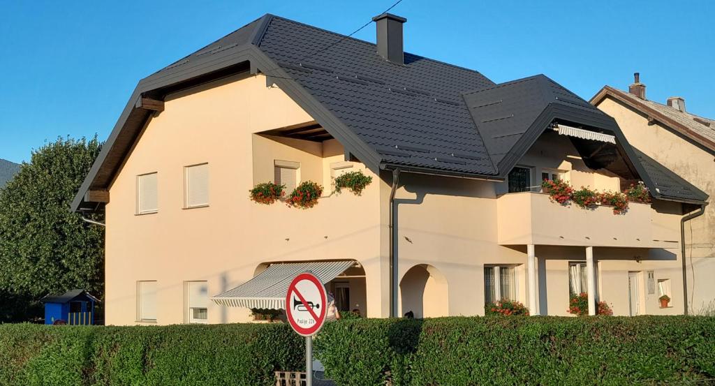 a house with a black roof and a no parking sign at Apartment Sky in Korenica