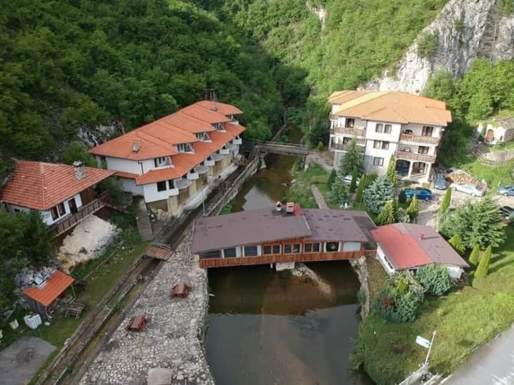 an aerial view of a house with a bridge over a river at Eco Complex Smilyan in Smilyan