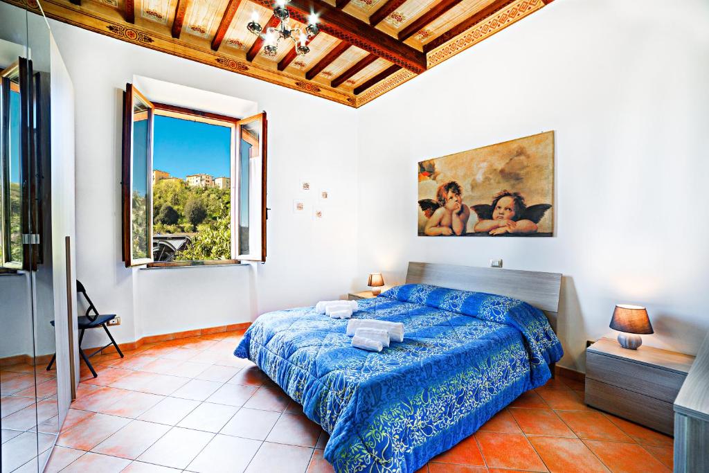 a bedroom with a bed and a large window at La casa di Giulina in Siena