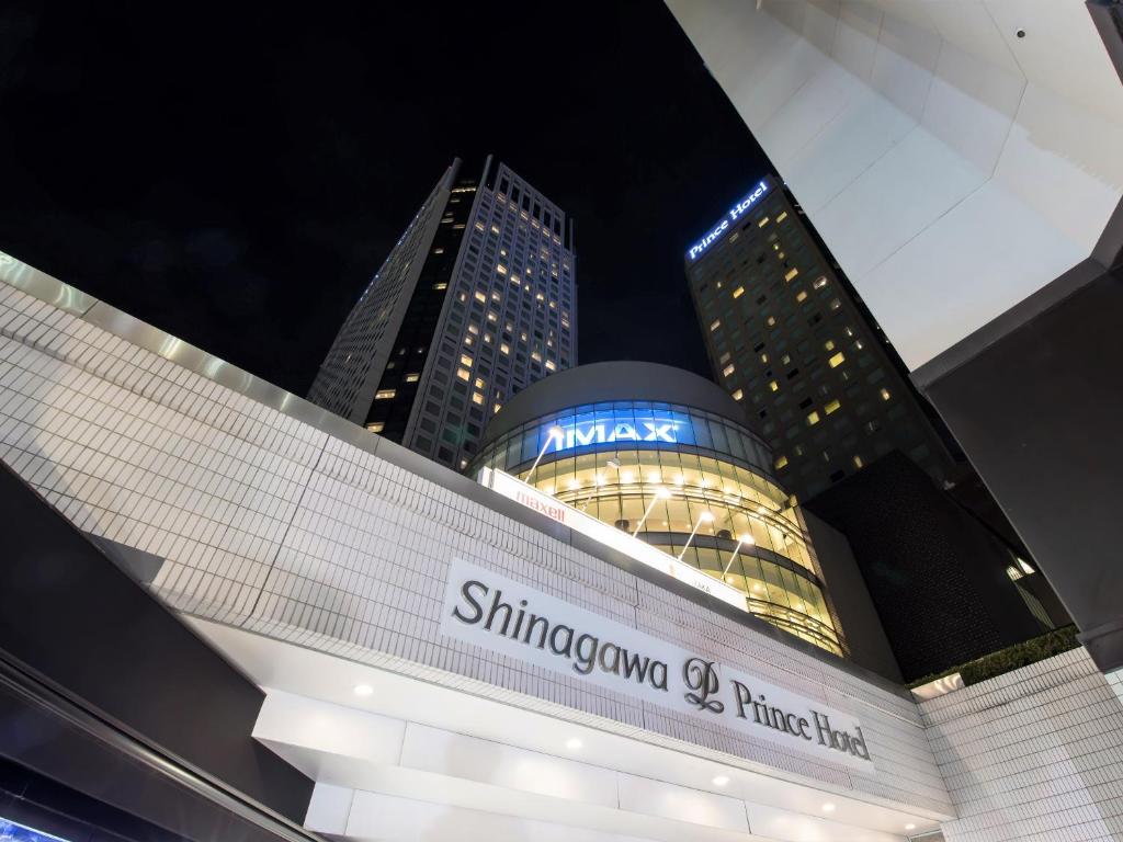a building with a singaporeapore times hotel sign at night at Shinagawa Prince Hotel in Tokyo