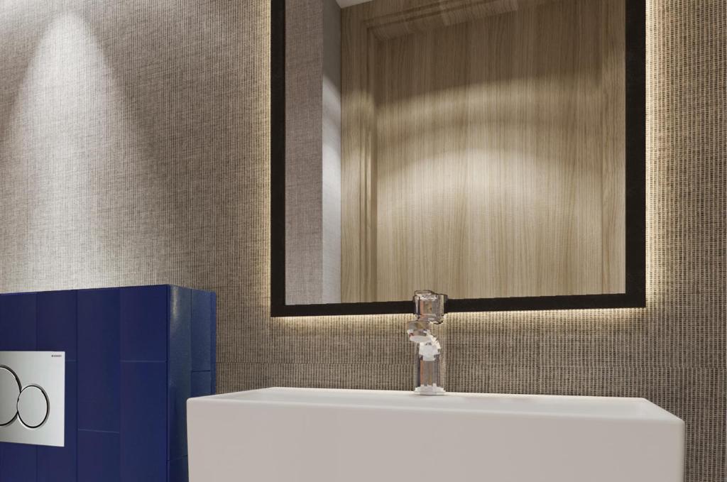 a bathroom with a white sink and a mirror at Erzurumlu Hotel in Kilyos