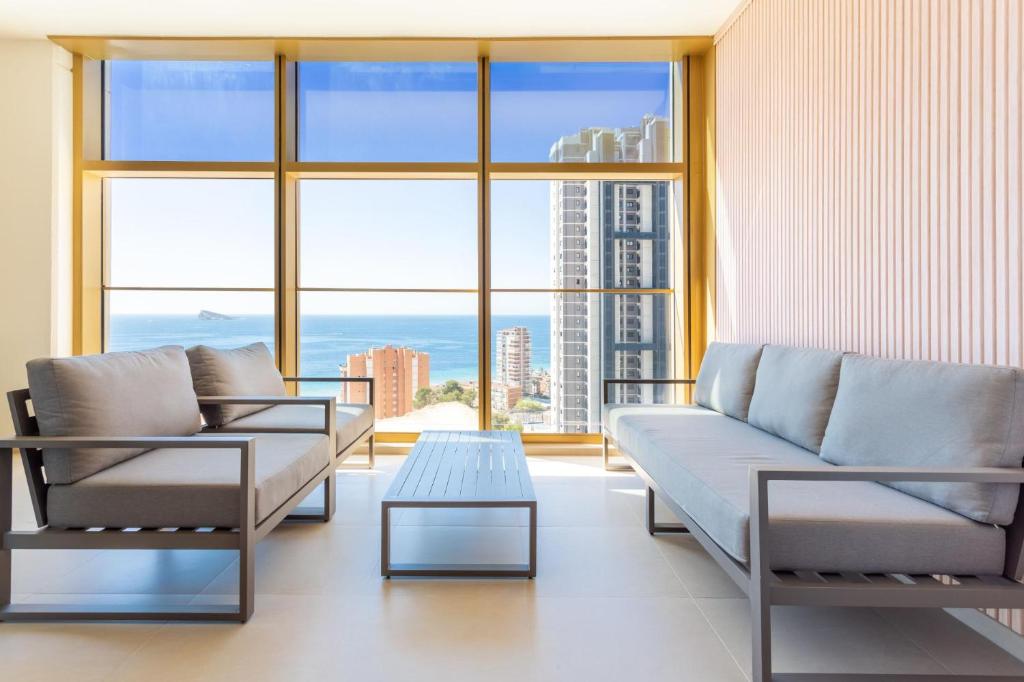 a living room with two couches and a table at Intempo Sky Apartments 056 in Benidorm