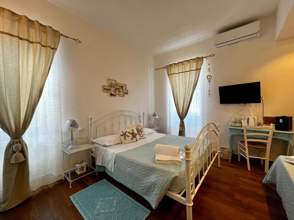 Postel nebo postele na pokoji v ubytování Palmasera Charming Rooms