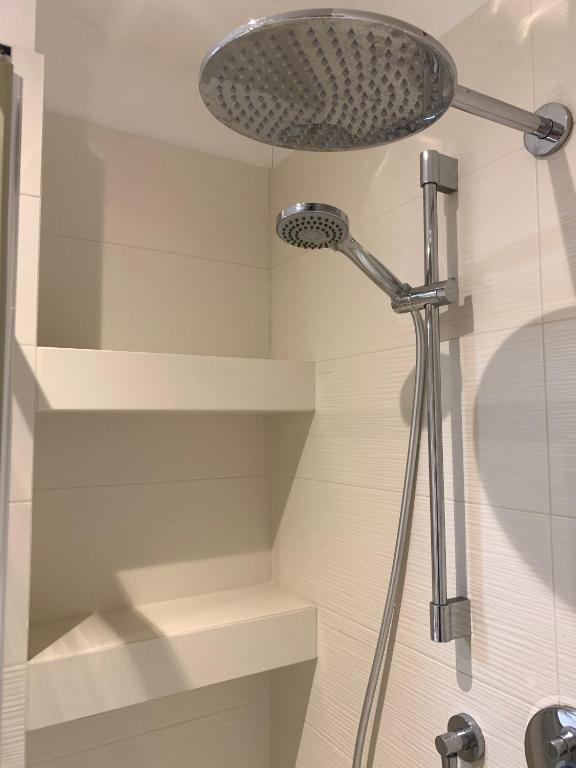 a shower with a shower head in a bathroom at San Giuseppe Casa per Ferie in Quercianella