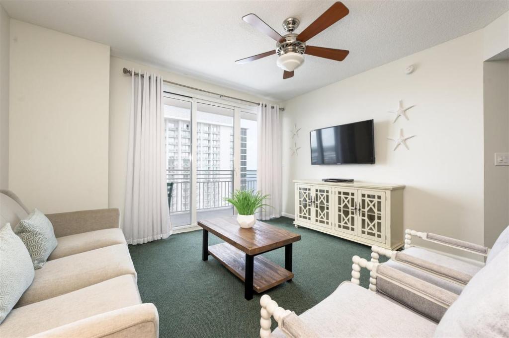 a living room with a couch and a tv at Unit 2432 Ocean Walk - 2 Bedroom Ocean View in Daytona Beach