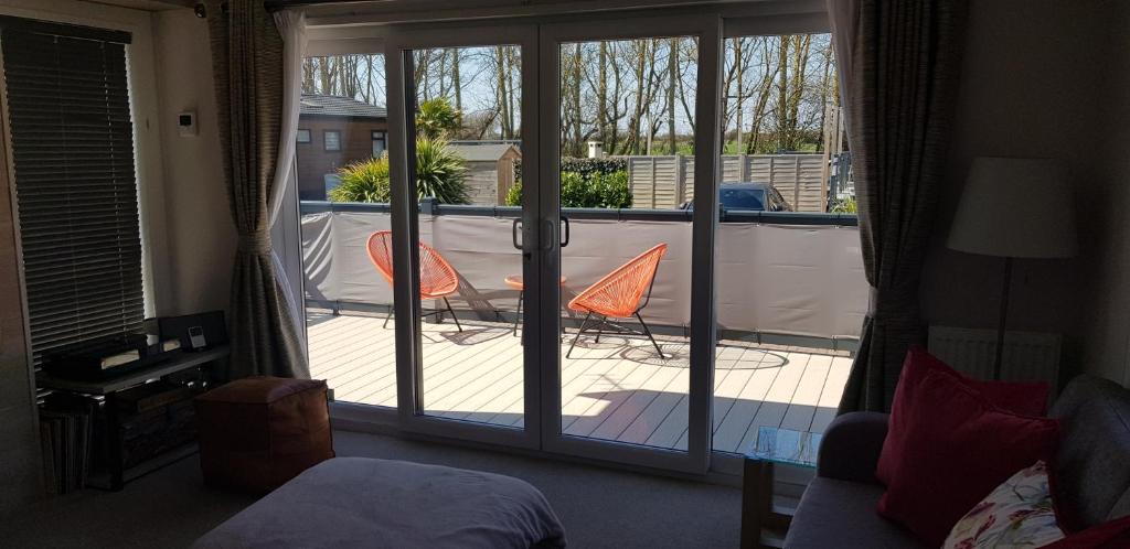 a bedroom with a sliding glass door to a balcony at Boulevard in Selsey