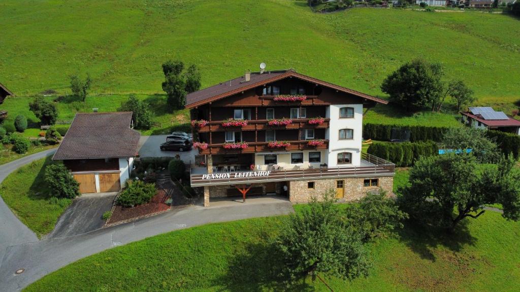 an aerial view of a large building on a hill at Pension Leitenhof in Niederau