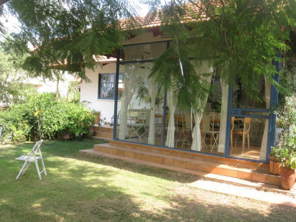 a house with a table and chairs in the yard at Barud Gedera Israel in Gedera