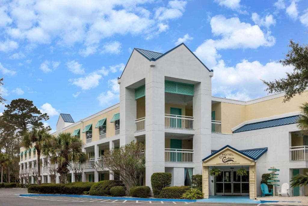 a rendering of the exterior of a hotel at Hotel Carolina A Days Inn by Wyndham in Hilton Head Island